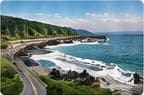 Coastal road curving along a rugged shoreline with waves